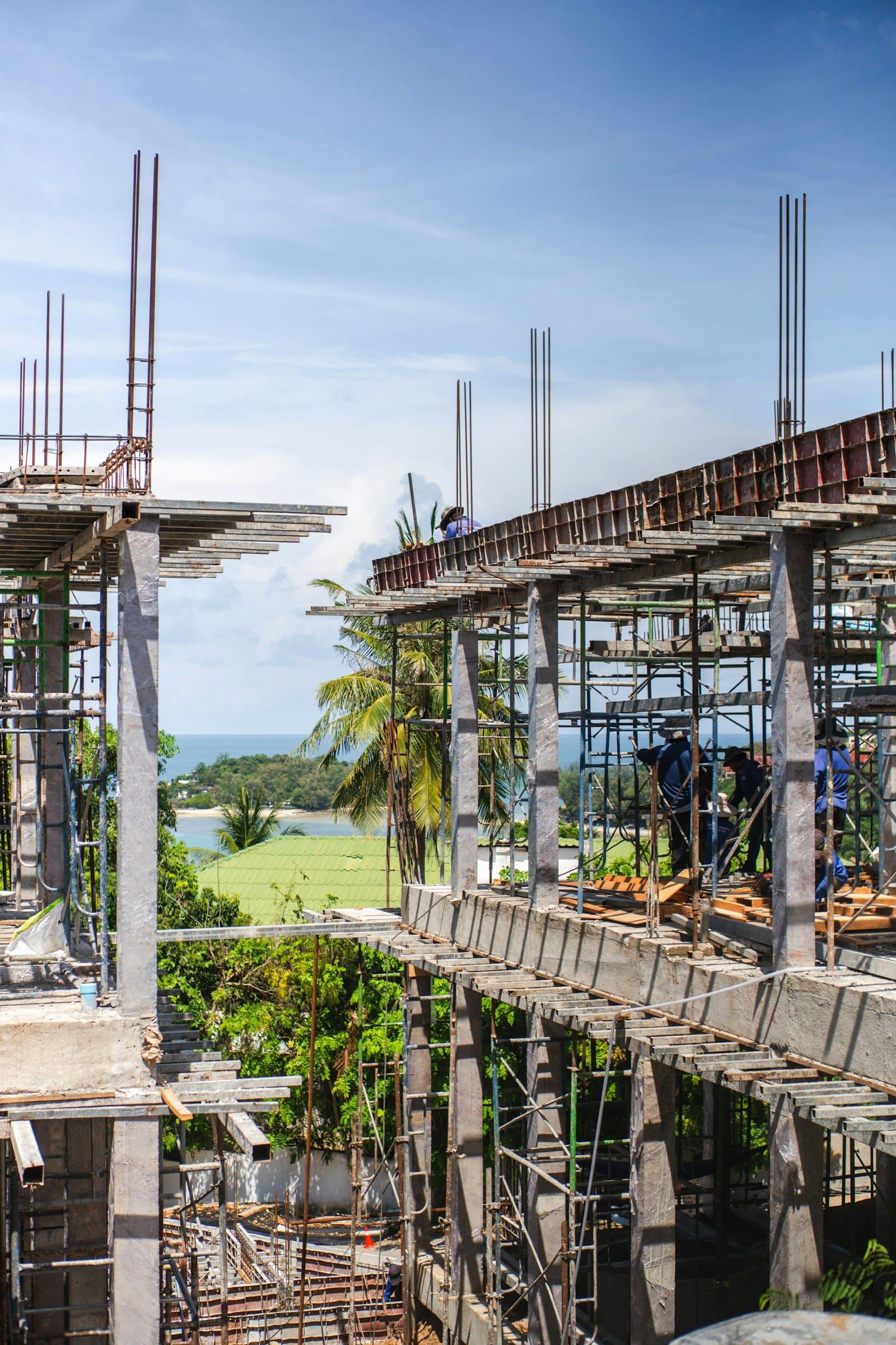 Crew working on a reinforced concrete frame with scaffolding